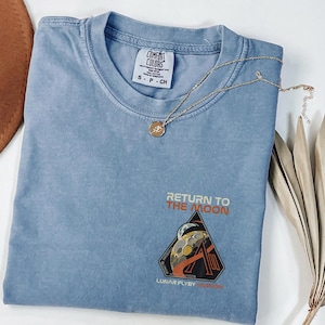 May include: A rustic wooden sign with the text "Welcome to our home" in white lettering. The sign features a distressed finish and a simple, inviting design, perfect for front door decor.