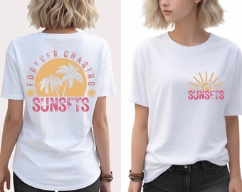 May include: White t-shirt with a graphic print of palm trees and a sun with the text "FOREVER CHASING SUNSETS". The same text appears on the front of the shirt in a smaller size with a sun graphic.