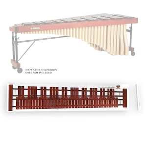 May include: A marimba runner with a dark brown wooden design. The text "5.0 Octave Marimba Runner" is visible. The image also shows a marimba for comparison, but it is not included.