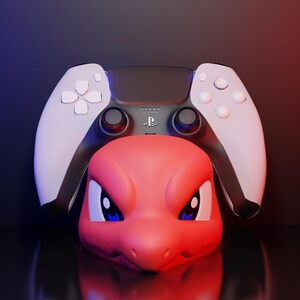 May include: A red and white video game controller with a red cartoon character head. The controller is white with black accents and buttons. The cartoon character has blue eyes and is red. The background is a gradient of blue and red.