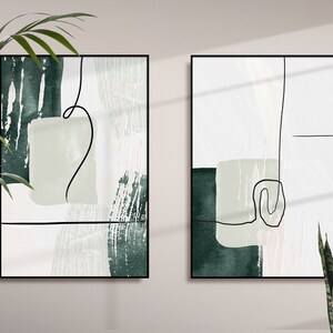 Pode incluir: Duas impressões de arte abstrata emolduradas com um esquema de cores verde, branco e cinza. As impressões apresentam formas e linhas abstratas.