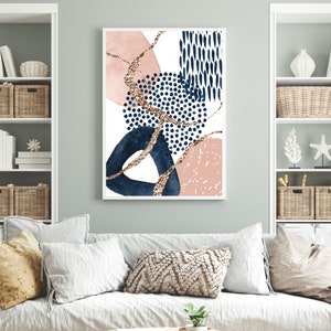May include: Abstract art print with a white backdrop, navy blue, blush pink, and gold glitter details. The design incorporates geometric shapes and dotted patterns, offering a modern aesthetic. The artwork is framed in a white border.