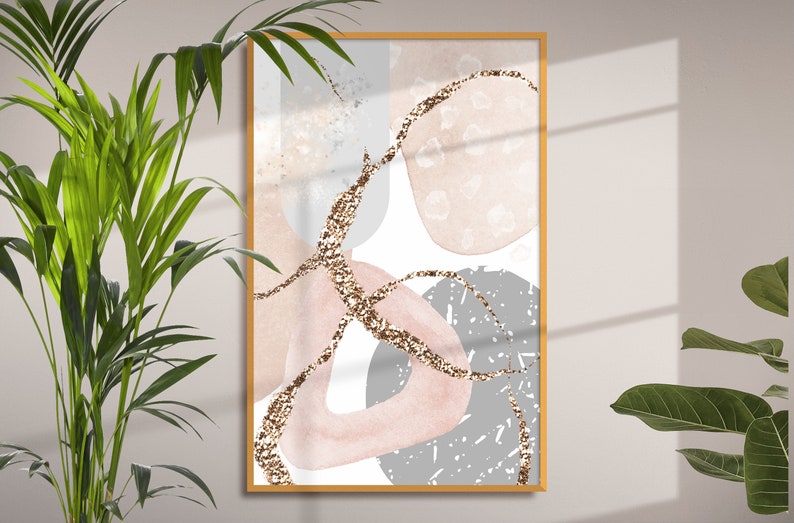 K&ouml;nnte beinhalten: Abstrakter Kunstdruck mit rosa, grauen und goldenen Formen auf wei&szlig;em Hintergrund. Der Druck ist in einem goldenen Rahmen gerahmt.