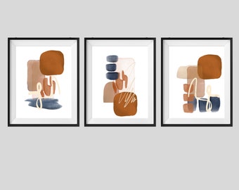May include: Set of three abstract art prints with geometric shapes in shades of brown, beige, and blue. The prints are framed in black.