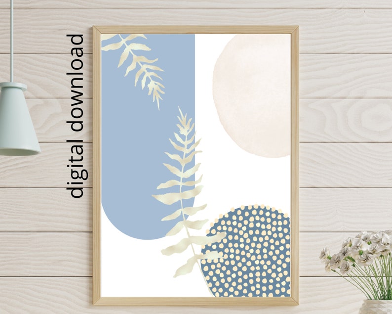 May include: Abstract art print with a blue and white color scheme. The print features two large circles, one with a white polka dot pattern and the other with a solid white fill. There are also two stylized fern leaves in a light gold color.