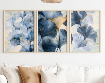 May include: Three framed prints with a watercolor style design of blue and gold leaves. The leaves are abstract and have a soft, flowing look.