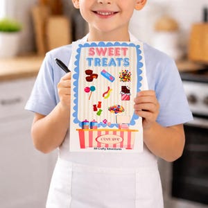 May include: A child holds a colorful "Sweet Treats" sign with candy illustrations. The sign features a blue scalloped border and a candy shop design at the bottom. A black pen is held in the child's other hand.