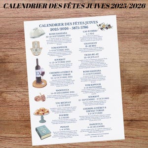 May include: A printed calendar titled "Jewish Holiday Calendar 2025/2026" with dates and illustrations. The calendar includes dates for Rosh Hashanah, Yom Kippur, Sukkot, Hanukkah, and other Jewish holidays. The calendar is on a wooden surface.