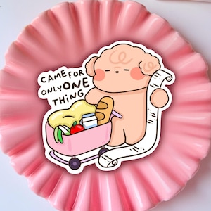 May include: A pink and white cartoon illustration of a sheep holding a shopping list and a shopping cart filled with groceries. The text on the image reads "Came for only one thing."