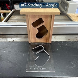 May include: A wooden box with a stocking cutout, labeled "#7 Stocking - Acrylic". A clear acrylic template of a stocking is also shown.