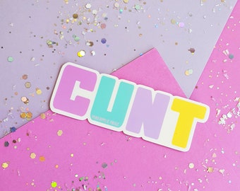 May include: A sticker with the word "CUNT" in rainbow colors on a pink and purple background with glitter. The sticker has the text "remarkable. nice" at the bottom.