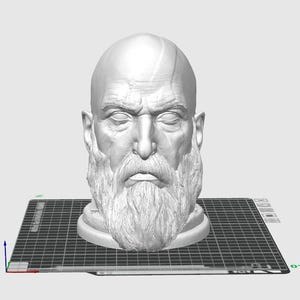 May include: A 3D printed bust of a man with a beard and a furrowed brow. The bust is printed in a light grey colour and is sitting on a black gridded surface.