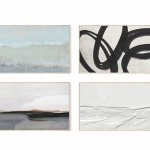 May include: Set of four abstract paintings in wooden frames. The paintings feature a variety of styles, including a blue and white landscape, a black and white abstract design, a white landscape with a textured surface, and a white landscape with a textured surface and a circle.