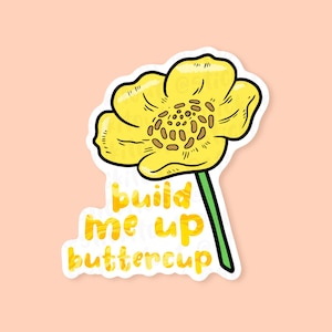 Build me up buttercup vinyl sticker placed on a peach background.
