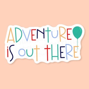 May include: A white sticker with a colourful handwritten message that says "Adventure is out there" with a blue balloon floating above the text.