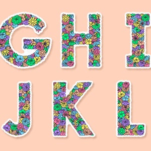 Peach background with G to L of the floral letter sticker designs spaced across. Each letter a variety of flowers & leaves in the shape of each letter of the alphabet, the flowers & leaves in a variety of colours.
