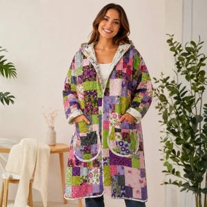 May include: A long-sleeved, knee-length hooded coat featuring a vibrant patchwork design. The garment is constructed from various fabric squares in shades of purple, green, pink, and white, and includes two large front patch pockets with white trim.