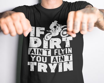 May include: Black t-shirt with a white graphic of a dirt bike rider and the text "If dirt ain't flyin you ain't tryin".