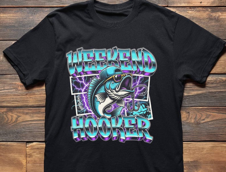 May include: Black t-shirt featuring a cartoon fish wearing sunglasses and a cap, with the words "WEEKEND HOOKER" in a blue and purple gradient font. The design includes a fishing hook and lightning bolts.