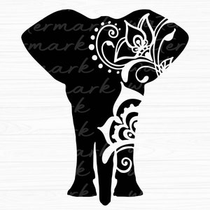 May include: Black silhouette of an elephant with intricate floral designs on its head and trunk. The elephant is facing right and has a detailed, stylized design.