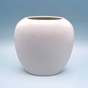 May include: A smooth, spherical ceramic vase with a glossy white finish. The vessel features a wide, rounded body that tapers slightly toward a circular opening at the top. The design is simple and uniform, showcasing a clean, reflective surface.