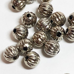 Distanziatori in metallo vintage: perline decorative rotonde da 7 mm (lotto da 24)