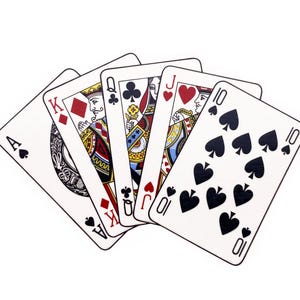 May include: A hand of playing cards showing an Ace of Spades, King of Diamonds, Queen of Clubs, Jack of Hearts, and a Ten of Spades. The cards are set against a white backdrop and are fanned out.