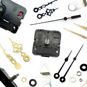May include: A collection of quartz clock movements, various styles of clock hands in black and gold, metal hangers, and small hardware components including nuts and washers. The black plastic clock mechanisms feature text markings.