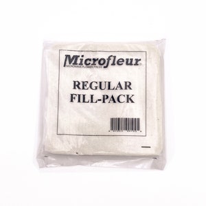 May include: A white package with the text "Microfleur Microwave Flower Press" and "Regular Fill-Pack" printed on it. A barcode is printed on the bottom of the package.