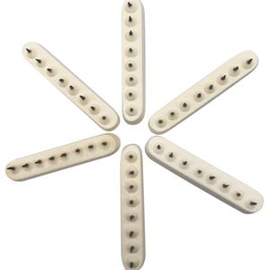 Puede incluir: Seis herramientas de madera rectangulares blancas con puntas de metal negro dispuestas en forma de estrella. Cada herramienta tiene 10 puntas de metal.