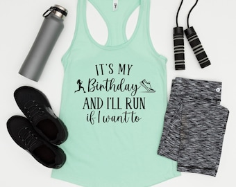 May include: A light mint green racerback tank top with black text that reads IT'S MY Birthday AND I'LL RUN if I want to, accompanied by a silhouette of a runner and a sneaker. Includes a gray water bottle, black sneakers, and a jump rope.