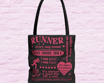 May include: Black tote bag with pink text that reads "RUNNER every step counts ONE MORE MILE YOUR RACE YOUR PACE RUN PROUD RUN STRONG It's always a good day for a run. When you feel like stopping, remember why you started."