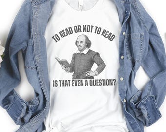 May include: White t-shirt with a graphic of William Shakespeare holding a book, with the text "TO READ OR NOT TO READ IS THAT EVEN A QUESTION?" The shirt is layered under a blue denim jacket.