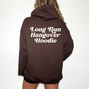 May include: A brown hoodie with the text "Long Run Hangover Hoodie" printed in white on the back.