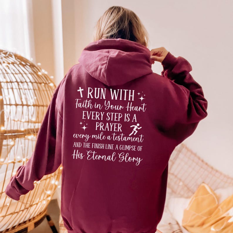 May include: Burgundy hoodie with a white graphic that reads "Run with faith in your heart, every step is a prayer, every mile a testament and the finish line a glimpse of His Eternal Glory".