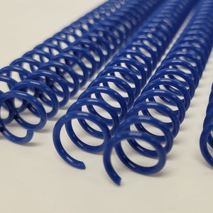 May include: Four blue plastic binding coils, also known as coil binding or spiral binding, are shown on a white surface. The coils are all the same size and are arranged in a row.