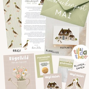 May include: A stationery set featuring a letter with mallard duck illustrations, a green envelope labeled Schneckenpost Mai, a cottage postcard, a scratch-off card, a packet of wildflower seeds, an iron-on transfer with a watering can, and two vinyl stickers.