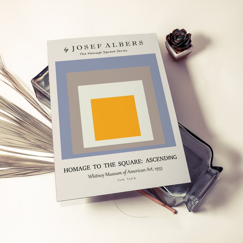 May include: A print of a geometric abstract painting by Josef Albers titled "Homage to the Square: Ascending". The painting features a series of squares in shades of grey, blue, and yellow.