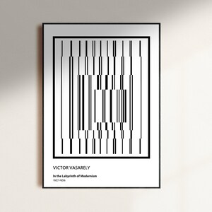 May include: Black and white geometric art print featuring a pattern of vertical lines. The print is framed in black and includes the text "VICTOR VASARELY" and "In the Labyrinth of Modernism 1963-1964."