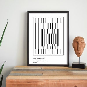 May include: Black and white geometric art print in a black frame with the text "VICTOR VASARELY In the Labyrinth of Modernism 1963-1969".
