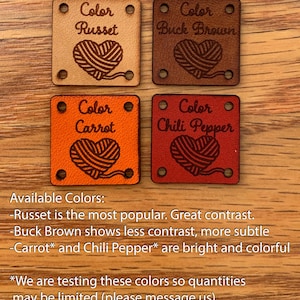 May include: Four leather squares with different colors and a heart-shaped yarn ball design. The colors are Russet, Buck Brown, Carrot, and Chili Pepper. The text "Color" is above each yarn ball design.