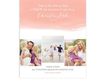 May include: A pink watercolor background with the text "Today in the town of David a SAVIOR has been born to you; He is Christ The Lord Luke 2:11"  Three photos of a family on a beach. The text "WARM WISHES for a CHRISTMAS filled with HIS AMAZING LOVE. THE WILLIAMS FAMILY" is below the photos. The text "FOTOVELLA HOLIDAY CARD 5 x 7, 2-Sided FLAT Card "Amazing" Photos © Chubby Cheek Photography chubbycheekphotography.com | Design © Fotovella | SKU: 1347" is at the bottom of the card.