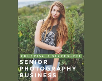 May include: A woman with long auburn hair wearing a gray tank top and denim shorts stands in front of green foliage. The tank top has a white graphic design. Text on the image reads: "CREATING A SUCCESSFUL SENIOR PHOTOGRAPHY BUSINESS."
