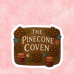 May include: A sticker featuring a wooden sign with the text "THE PINECONE COVEN" in cream-colored letters. The sign is decorated with pinecones, flowers, and small jars of jam. The background is a soft pink.