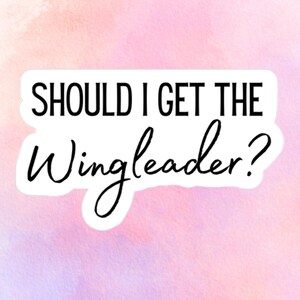 May include: A sticker with the text "SHOULD I GET THE Wingleader?" in black font. The sticker is set against a watercolor background of pink, purple, and peach hues.