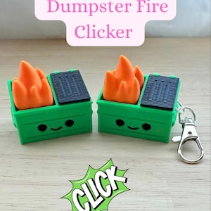 May include: Two green dumpster-shaped clickers with orange flames and black lids. Each has a smiling face and a silver keychain clasp. The text "Dumpster Fire Clicker" is above the clickers, and the word "CLICK" is in a green burst.