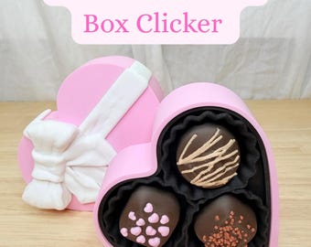 Juguete sensorial multiclic con forma de caja de chocolate con forma de corazón para aliviar la ansiedad y decorar el escritorio kawaii. Fidget clicker impreso en 3D.