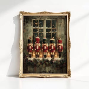 May include: Framed artwork featuring five toy nutcrackers in red and black uniforms, standing in front of a window with a snowy scene. The artwork is in a gold ornate frame, with lit candles and greenery below the nutcrackers.