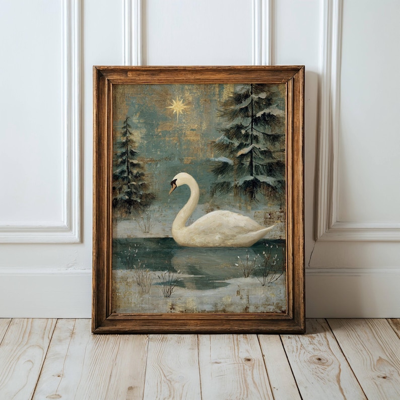May include: Framed artwork featuring a white swan on a lake surrounded by snow-covered pine trees. The painting has a vintage aesthetic with a gold star in the sky and a wooden frame.