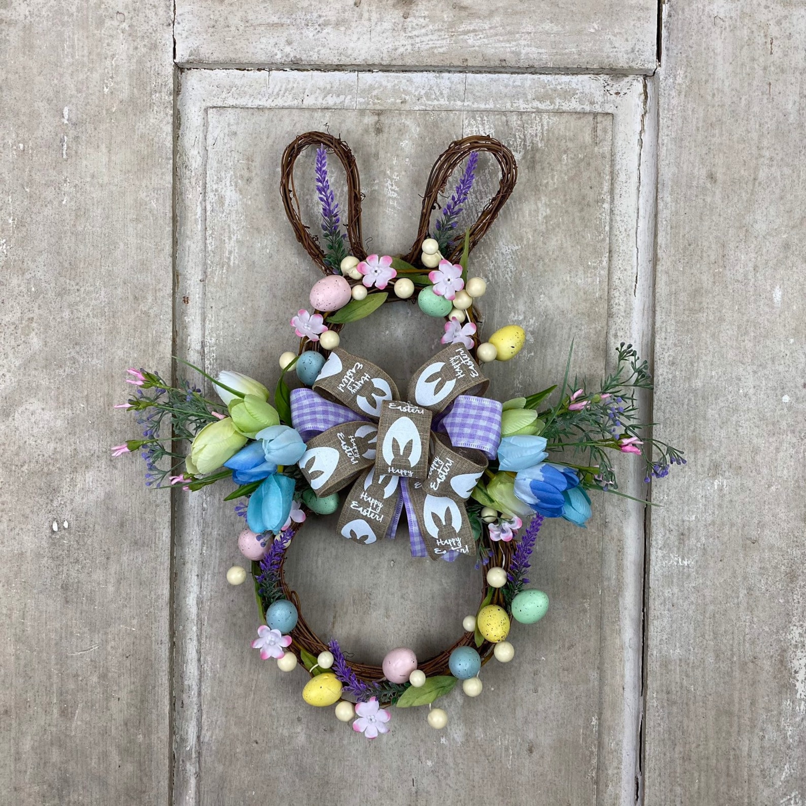 Bunny Shaped Grapevine Wreaths with Flowers, Greenery, Eggs and Twig Berries Bunny Shaped Grapevine Wreaths with Flowers, Greenery, Eggs and Twig Berries